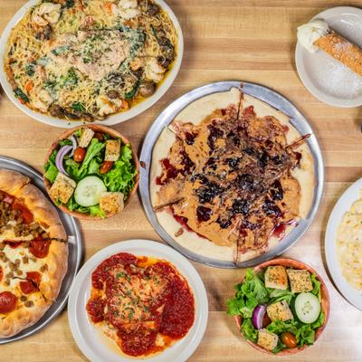 An assortment of dishes spread on a table, top view.