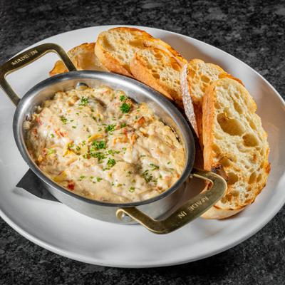 Otto Dip served in a small metal skillet with a side of toasted ciabatta.