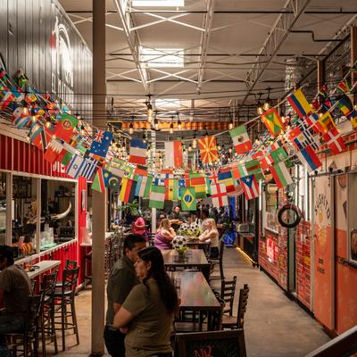 Various countries flags hanging above the tables.