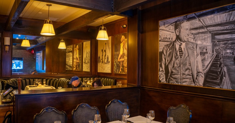 Exterior, seating area with a fire pit, string lights, and plants under a white canopy