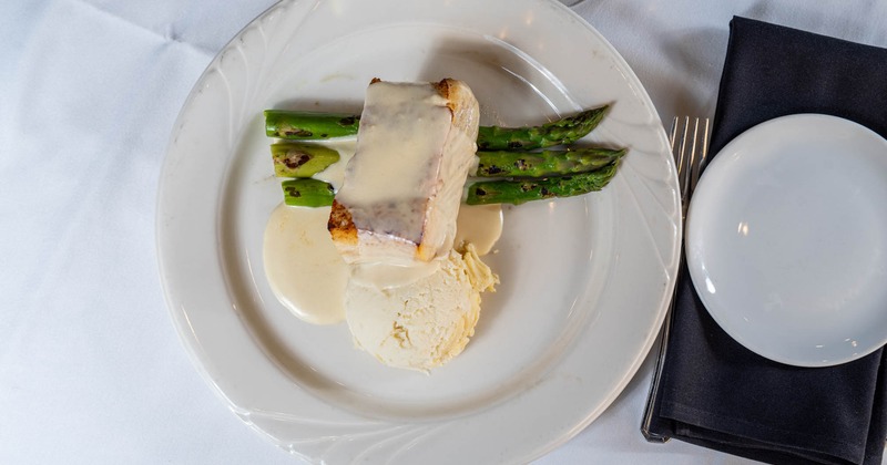 Halibut filet in lemon butter sauce, served with grilled asparagus and mashed potatoes