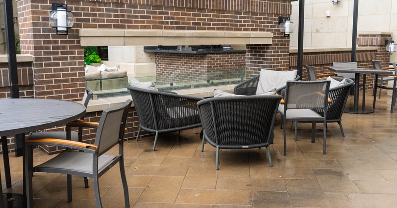 Exterior, seating area, plastic wicker armchairs with coffee table, large fire pit