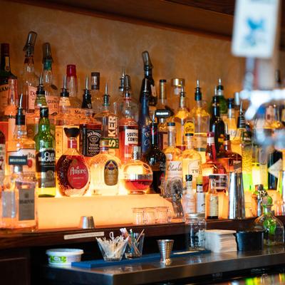 Liquor bottles on bar shelves.