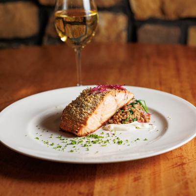 Herb-Parmesan-crusted salmon with farro and spinach served with white wine