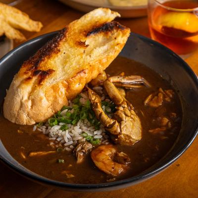 Seafood gumbo served with grilled bread.