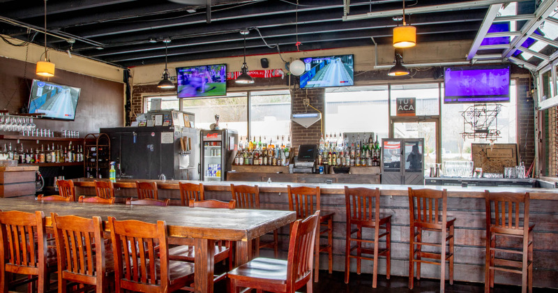 Interior, a long guest table and the bar in the back