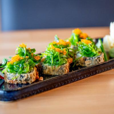Green Mountain Maki  topped with seasoned seaweed salad.