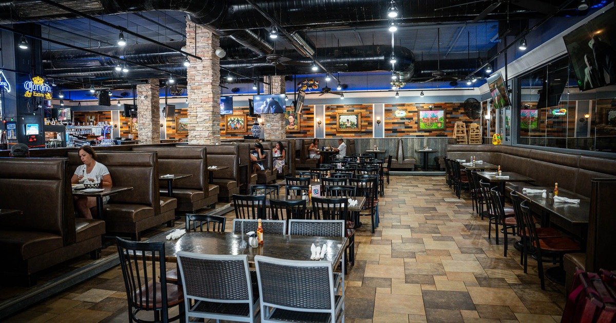 Interior of a modern restaurant with brown leather booths and tiled flooring