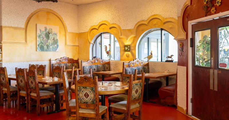 Interior seating area with double booths, chairs and tables, organic decoration