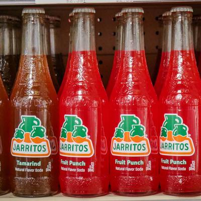 Mexican soda bottles on a shelf.