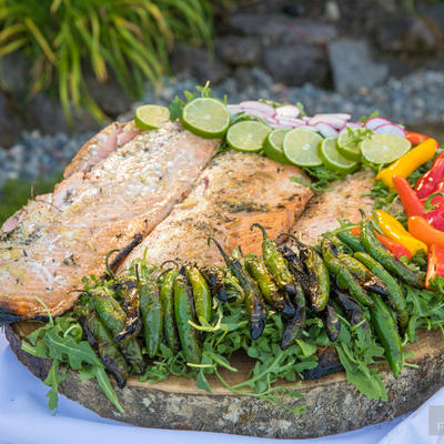 Grilled fish with chili peppers and cucumbers closeup