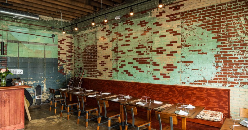 Interior, banquette seating and tables by a wall