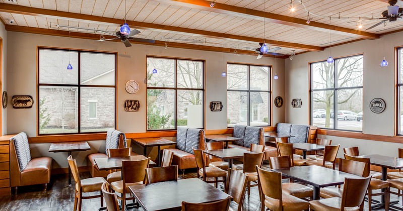 Dining area, seating booths by the windows, tables and chairs