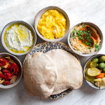 Assorted Mezze’s flavors and baked pita bread
