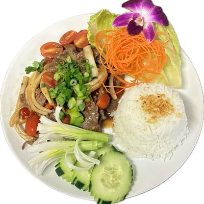 Stir-fried beef with rice, cucumbers, shredded carrots, tomatoes, and green onions.