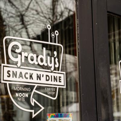 Exterior, restaurant window sign with white lettering.