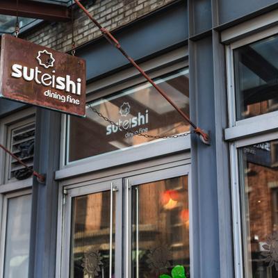 Restaurant entrance with a sign above the door.