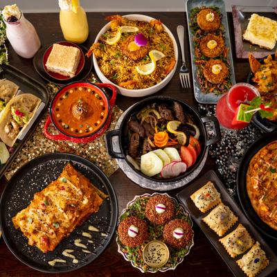 Miscellany of dishes and drinks displayed on a table, overhead view.