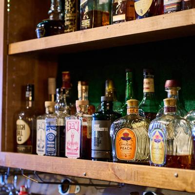 Various liquor bottles on the shelf.