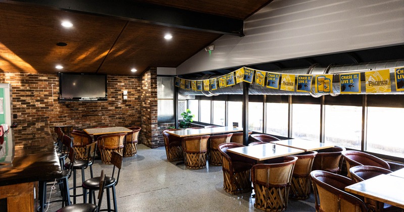 Cozy bar interior with wooden tables and brick walls