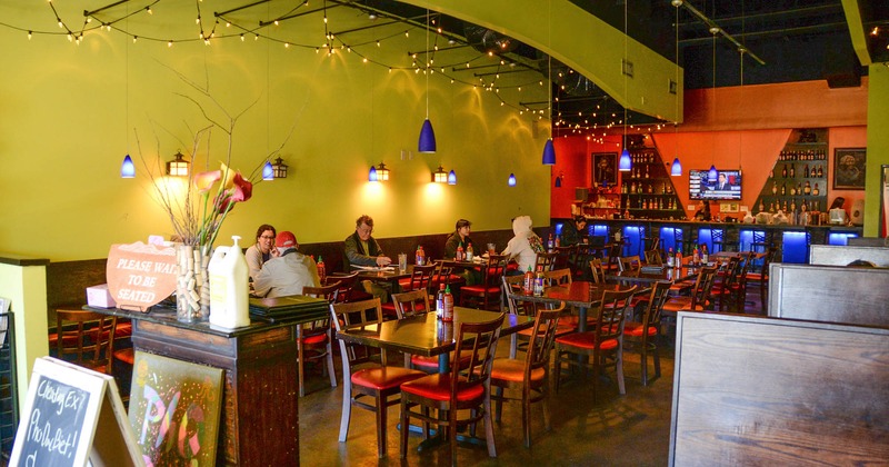 Interior, view of dining area, bar in the back