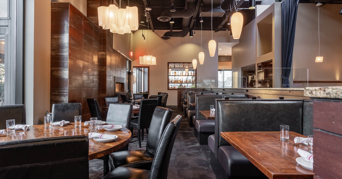Interior, dining area with booths on the right and tables with chairs on the left