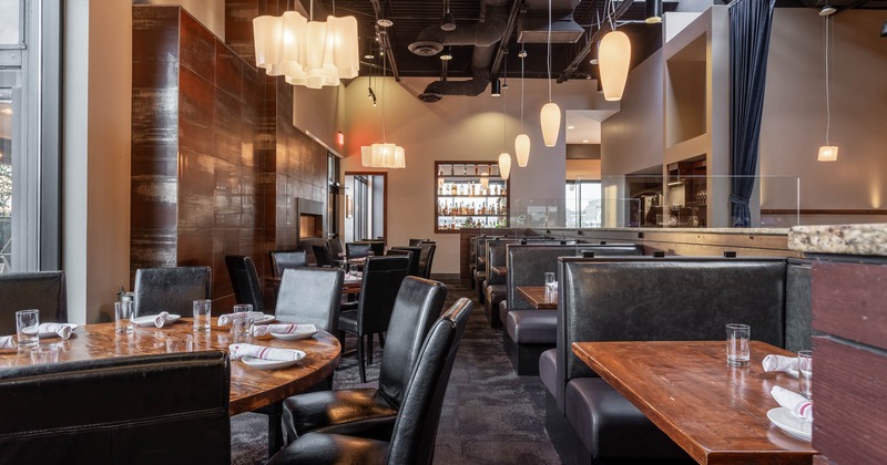 Interior, dining area with booths on the right and tables with chairs on the left