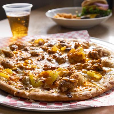 Buffalo chicken pizza with peppers and cheese.