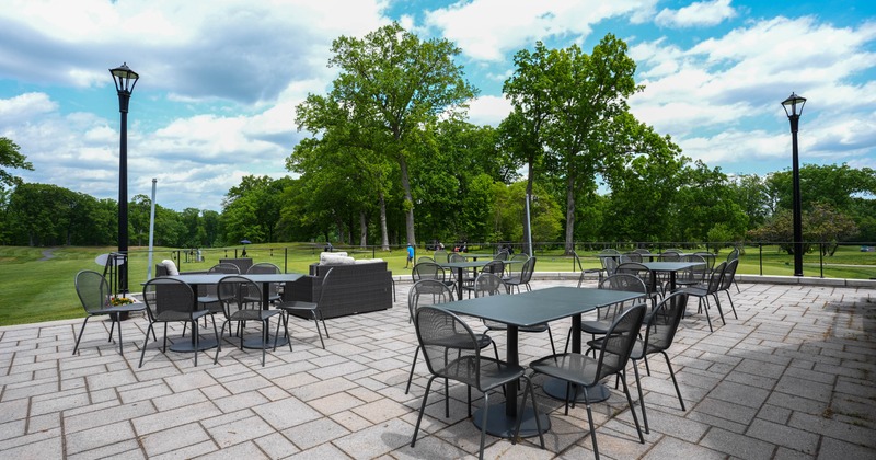 Outdoor patio, metal tables and chairs on a paver surface