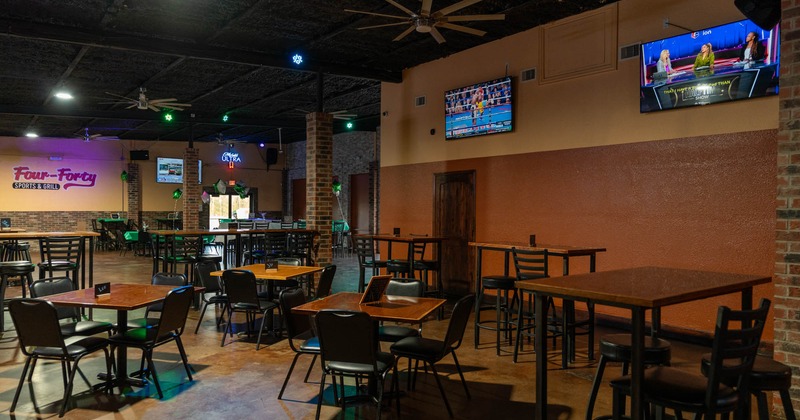 Interior, chairs and tables, TV's on the wall