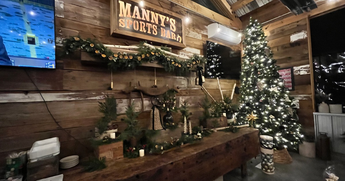 Cozy barn interior with a Christmas tree and festive decorations