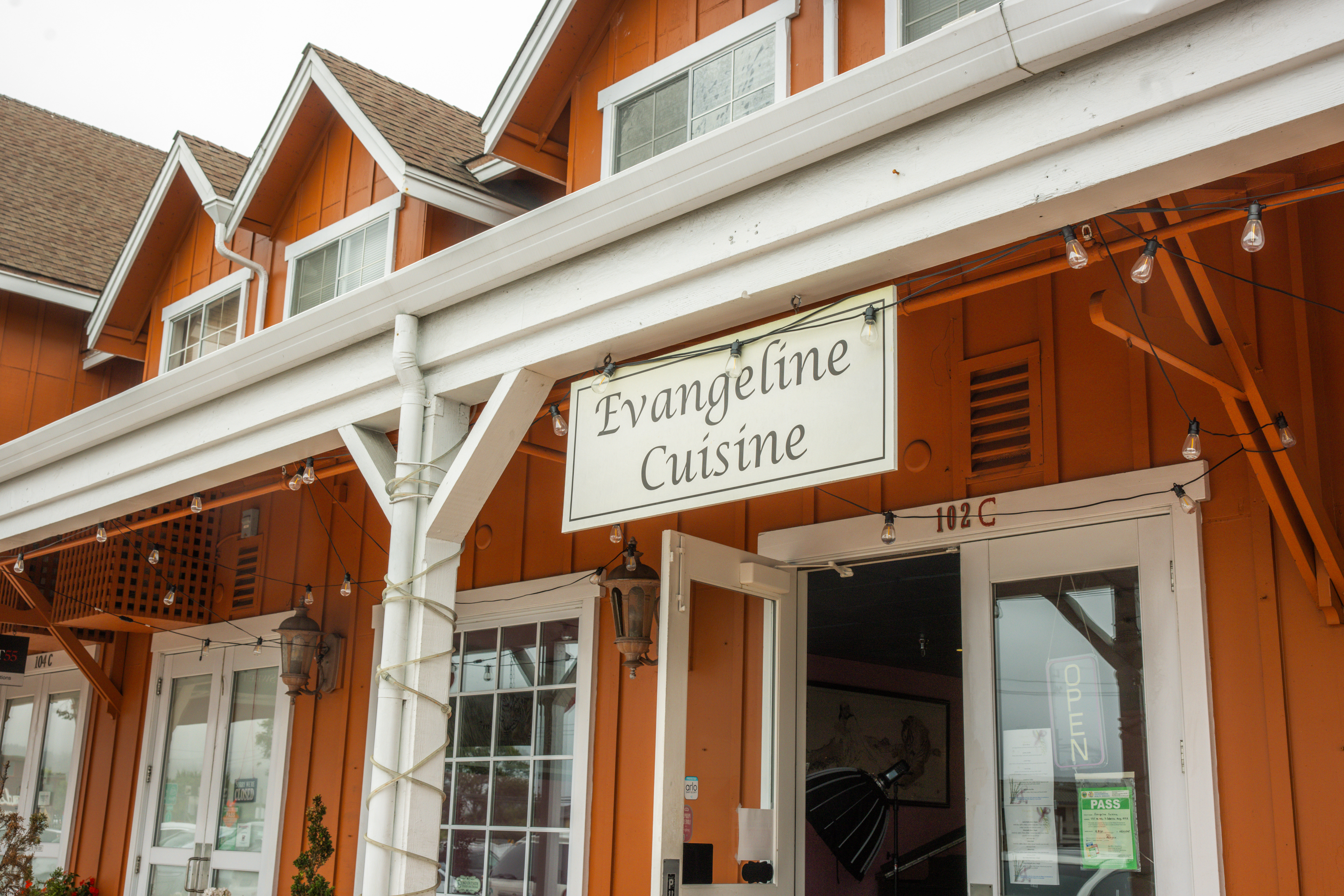 Exterior, sign above entrance, hanging wooden board