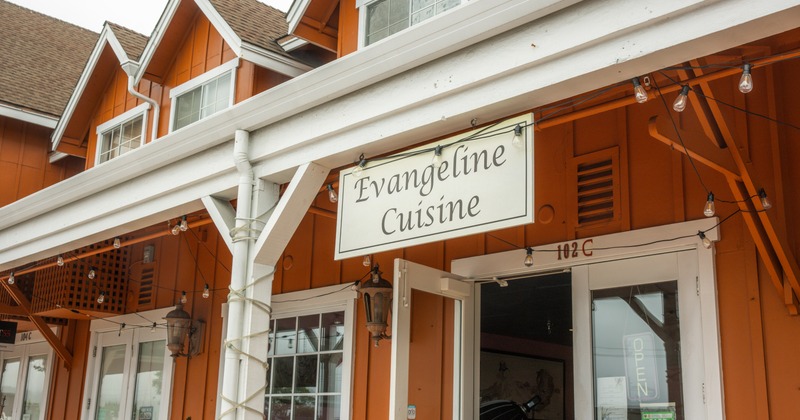 Exterior, sign above entrance, chain hanging wooden board