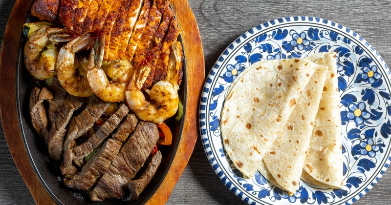 Fajitas Trio skilled served with tortillas on the side