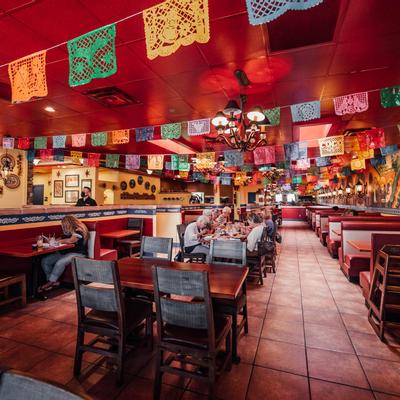 Dining room interior, tables and seating, fiesta banners on the ceiling