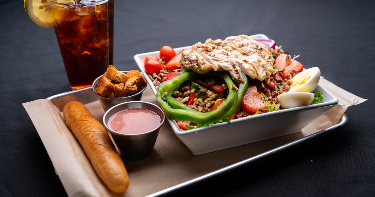 Strawberry Pecan Chicken Salad served with sides and a drink