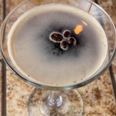 Creamy espresso martini garnished with coffee beans.