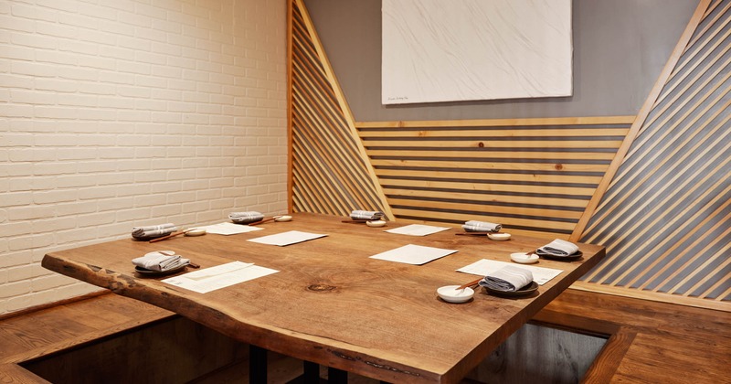 A big table in the corner with tableware