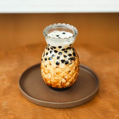 Brown Sugar Latte with boba pearls served on a tray.