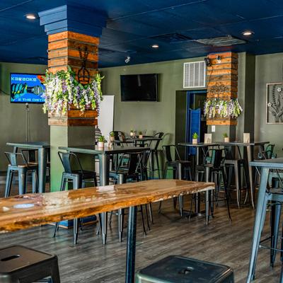 Interior, seating area with bar tables and bar chairs.