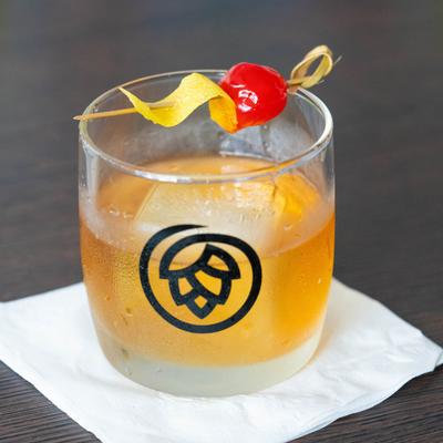 Classic Old Fashioned in a glass with the restaurant's logo.
