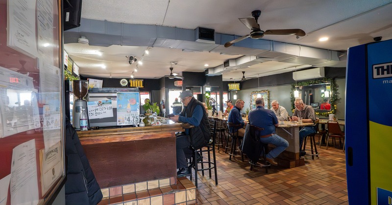 Interior, bar and seating area with guests