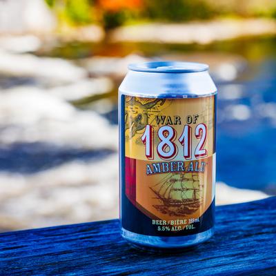 A can of house-brewed beer on a wooden table.