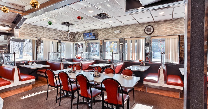 Interior, wide view, tables, chairs and red leather benches