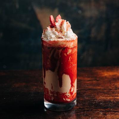 Strawberry shortcake milkshake served in a glass.