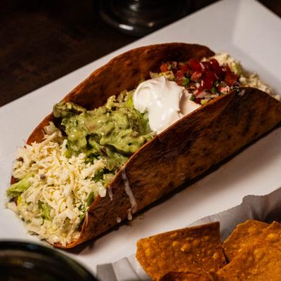Taco salad served in a crispy flour tortilla shell.