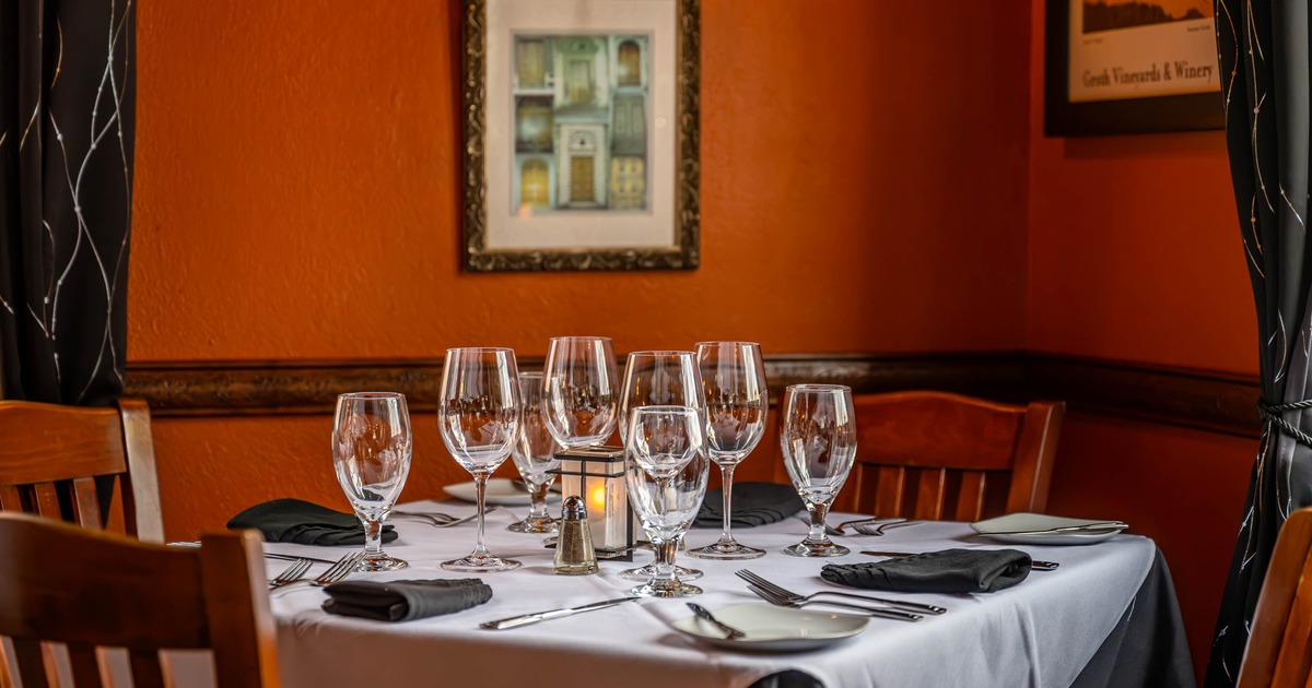Interior, table set for guests in dining area