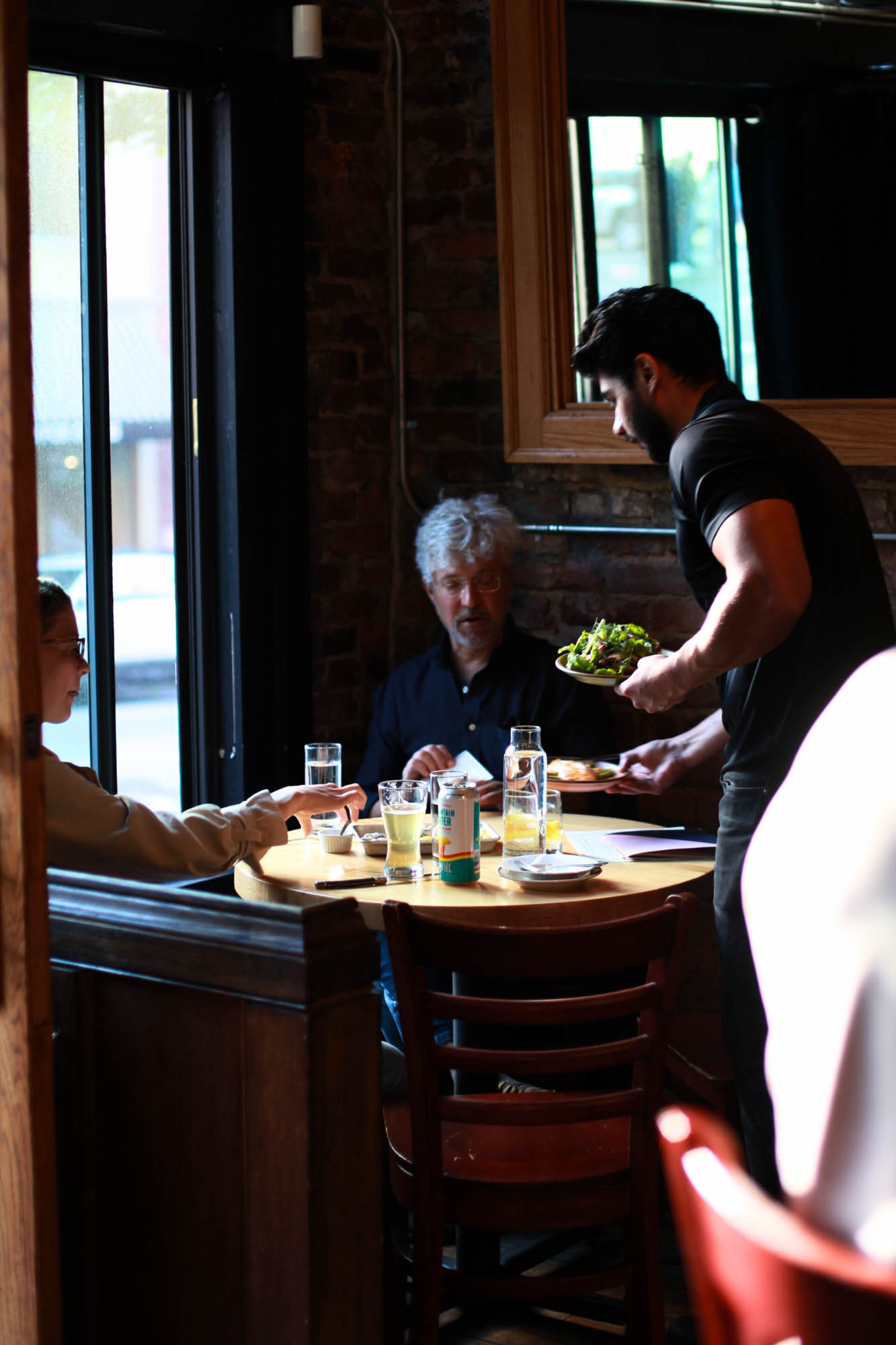 Graciously serving guests some amazing dishes!