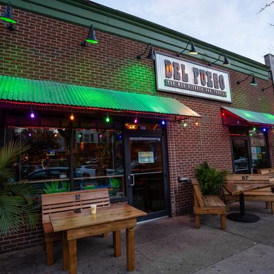 Exterior, seating area, tables by the front entrance.