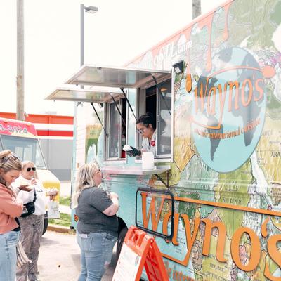 The food truck counter, people waiting for food.